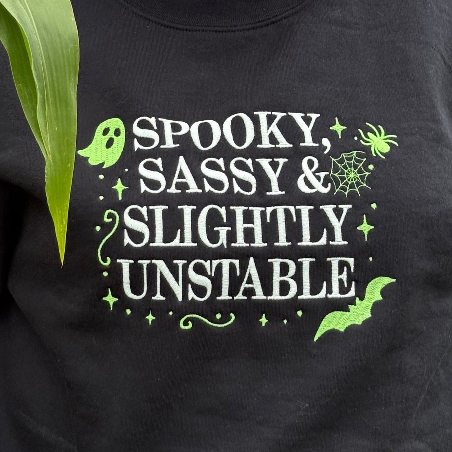 Person wearing a black sweatshirt with text in a natural setting