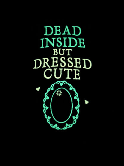 Glowing text 'Dead Inside But Dressed Cute' with a decorative border on a black background