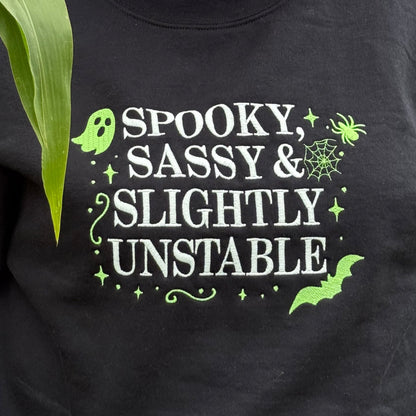 Person wearing a black sweatshirt with text in a natural setting